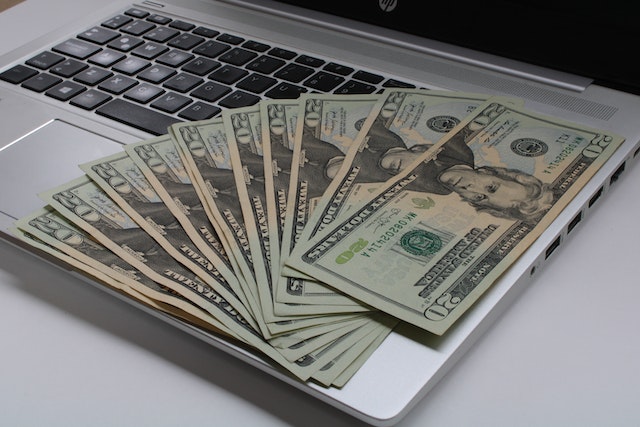 money sitting on a laptop